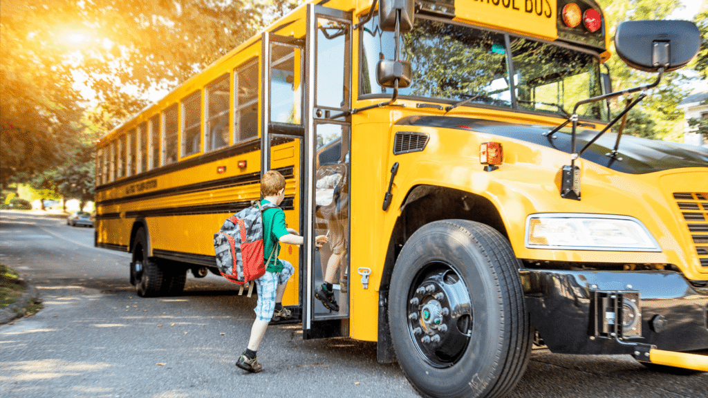 Child boarding a yellow school bus