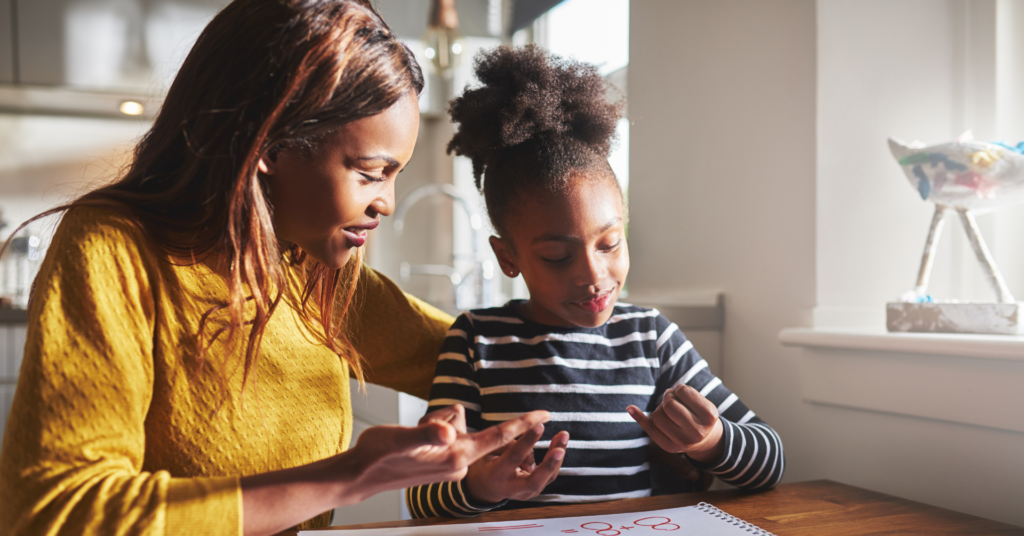 Mother and daughter doing an activity together at a table