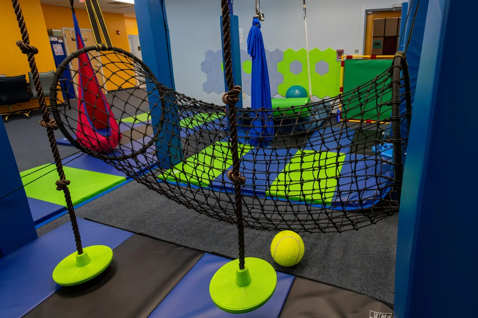 Indoor play gym with net climber and sensory equipment