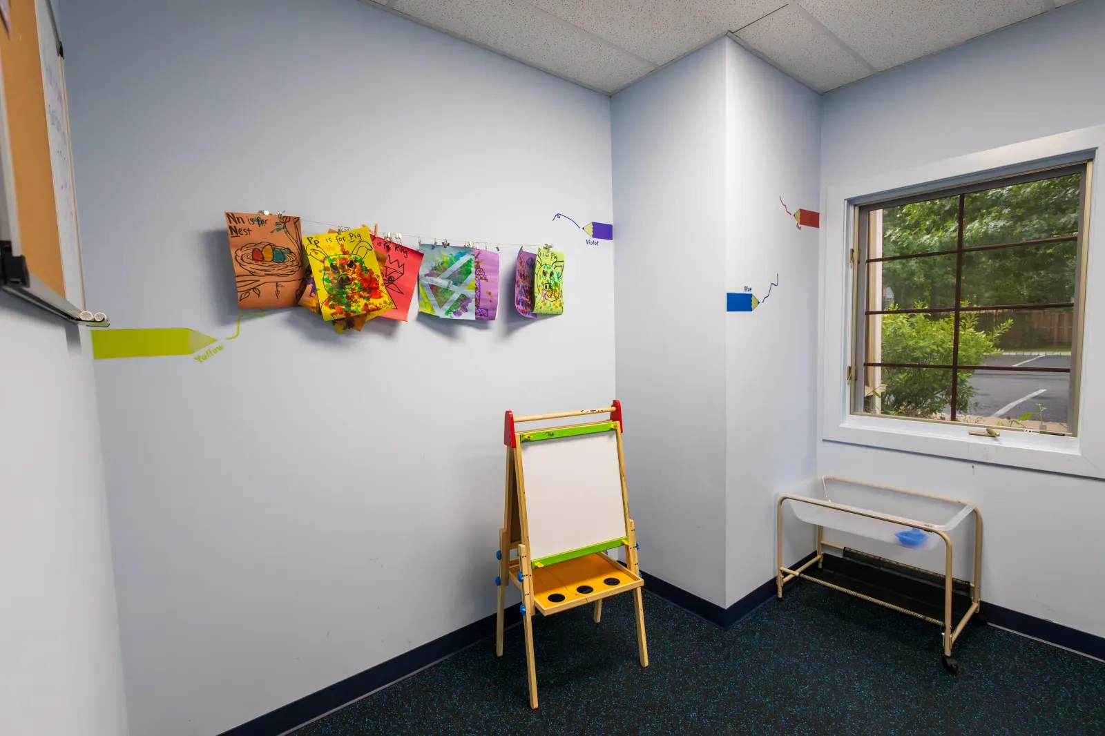 Bright therapy room with wall letters and easel