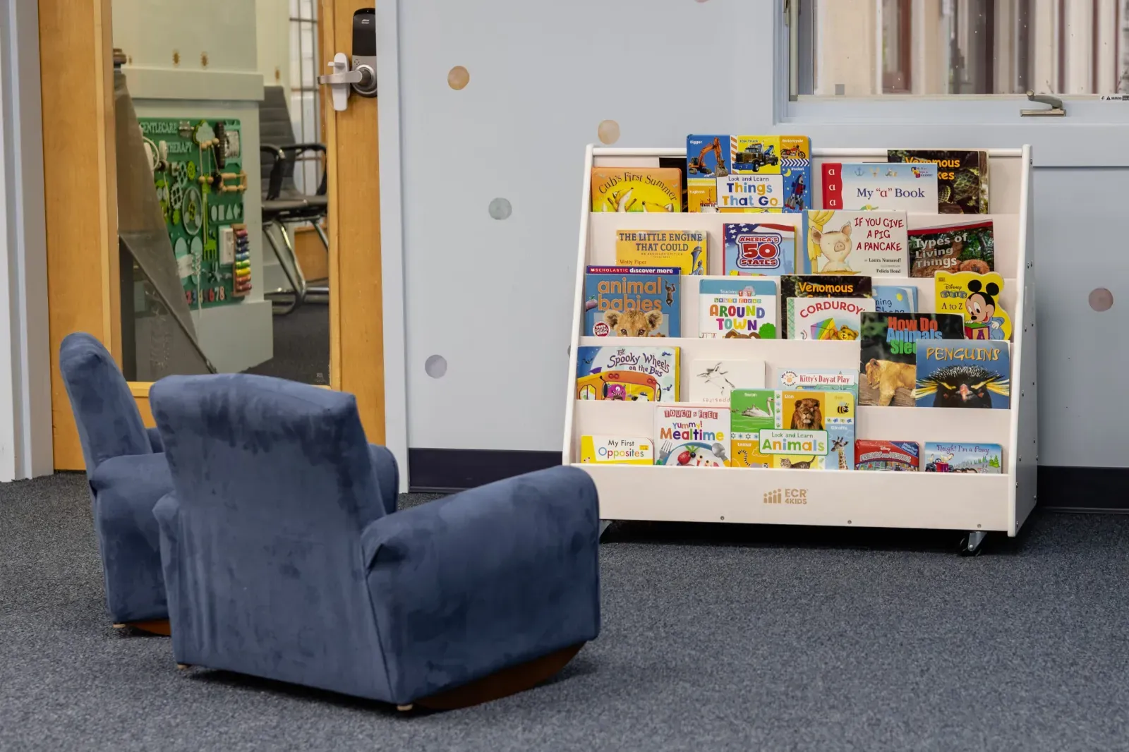 Quiet library room with bookshelf and armchairs